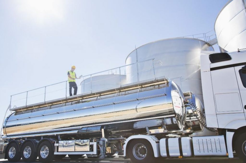 Workers on a stainless steel milk tanker